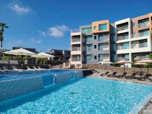 a swimming pool in front of a building at Villa de Aewol in Jeju