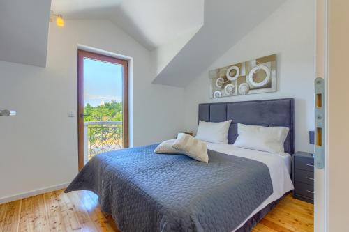 a bedroom with a bed and a large window at Villa Izabela with private pool and beautiful view in Dračevica