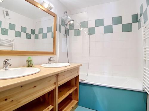 a bathroom with two sinks and a tub at Appartement Les Menuires, 6 pièces, 12 personnes - FR-1-344-775 in Levassaix