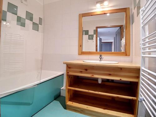 a bathroom with a sink and a mirror at Appartement rénové proche pistes avec Sauna, Hammam et WIFI - FR-1-344-788 in Levassaix