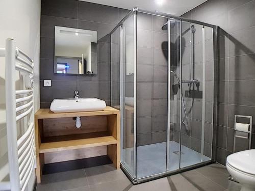 a bathroom with a shower and a sink at Appartement de standing rénové aux Belleville avec balcon, accès pistes, WiFi, sauna et hammam - FR-1-344-808 in Levassaix