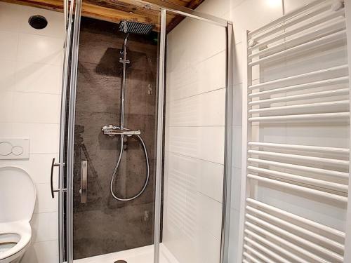 a shower stall in a bathroom with a toilet at Appartement Les Menuires, 2 pièces, 6 personnes - FR-1-344-831 in Levassaix