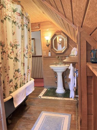a bathroom with a sink and a toilet in a room at Gold Mountain Manor in Big Bear City