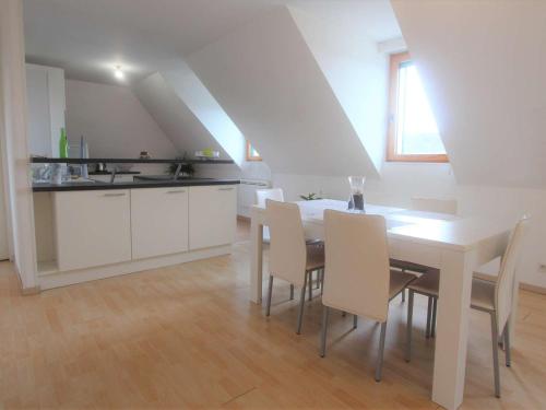 a kitchen and dining room with a table and chairs at Appartement La Forêt-Fouesnant, 3 pièces, 4 personnes - FR-1-481-121 in La Forêt-Fouesnant