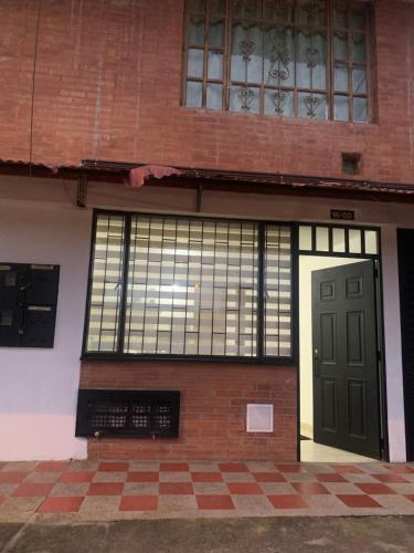a brick building with a door and windows at Bellísimos apartamentos céntricos en La Mesa in La Mesa