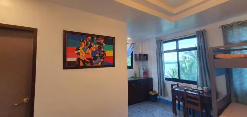 a room with a painting hanging on the wall at West Atlantic Inn in Concepcion