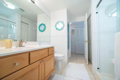 y baño con lavabo, aseo y ducha. en Beach Living at the Retreat en Driftwood Village