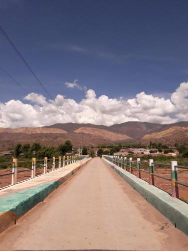 a bridge over a road with mountains in the background at Posada Huacalera (Tropico de Capricornio) in Huacalera