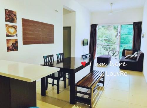 a dining room and living room with a table and chairs at Golden Hills Pasar Malam 3 Bedroom Apartment J LouvRe in Tanah Rata