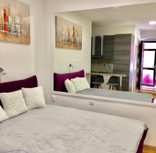 a bedroom with a bed and a kitchen at Sweet studio apartment Living in Rijeka in Rijeka