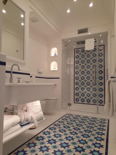 a bathroom with a shower and a sink and a toilet at Hotel Marincanto in Positano