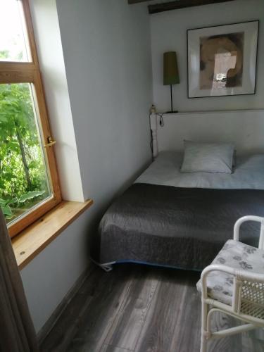 a small bedroom with a bed and a window at Secret garden house in the center of Sigulda in Sigulda