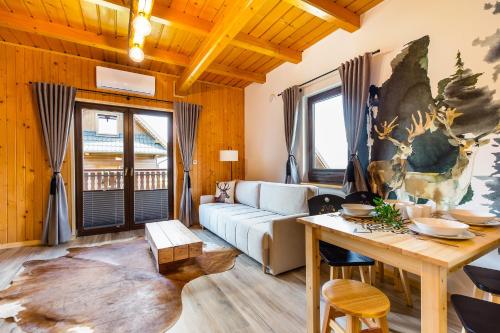 a living room with a couch and a table at Mergen Bike & Ski Resort in Niedzica Zamek