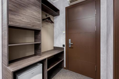 a walk in closet with a wooden door at Kope Palace in Tbilisi City