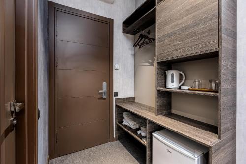 a walk in pantry with a wooden door at Kope Palace in Tbilisi City