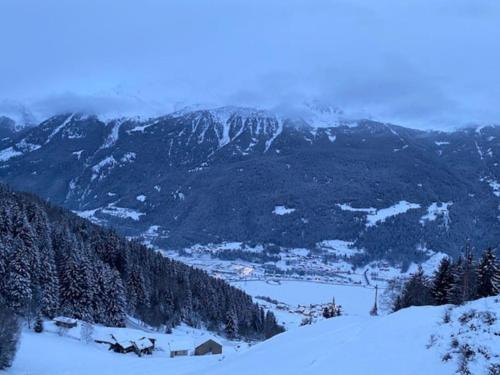 a view of a snow covered mountain with a town at Appartamento trilocale luxory,sulle piste da sci in Bormio