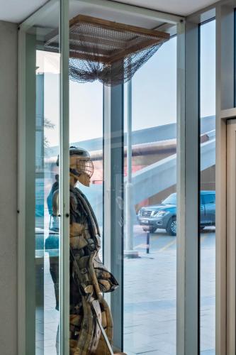 a mannequin is standing in a glass window at Emirates Sports Hotel, Dubai Sports City in Dubai