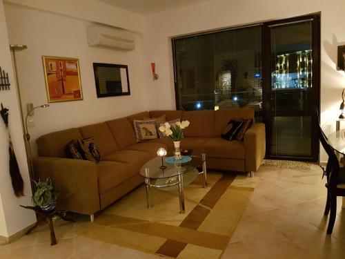 a living room with a couch and a table at Ravda Sun Sea Ressort 2 in Ravda