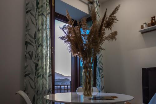 a vase of flowers on a table in front of a window at VeraLuce in Caltavuturo