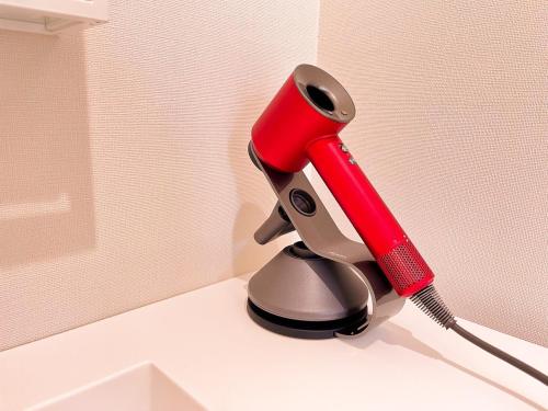a red hair dryer sitting on top of a counter at Necoana Glamping in Fujikawaguchiko