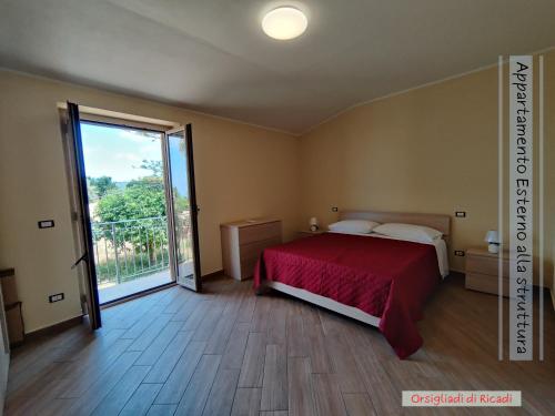a bedroom with a bed and a large window at Gullo Capo Vaticano in Ricadi