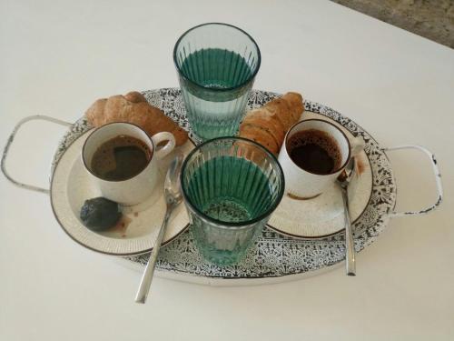 a plate of pastries and two cups of coffee at PRINCESS OF BLUE EAGLES RETREAT in Skaloma
