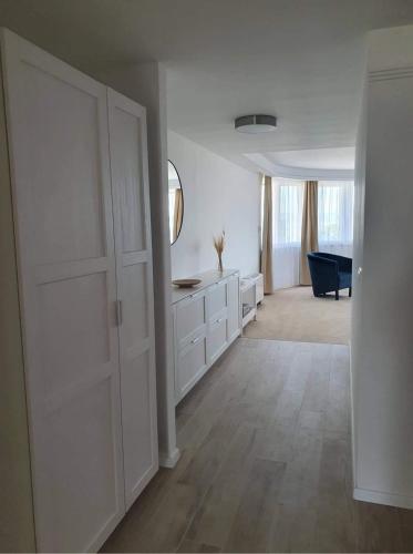 a white room with a door and a living room at Holiday Resorts in Balatonszárszó