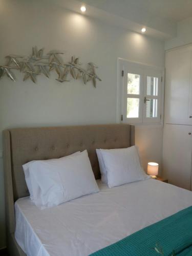 a bedroom with a bed with white sheets and pillows at PRINCESS OF BLUE EAGLES RETREAT in Skaloma