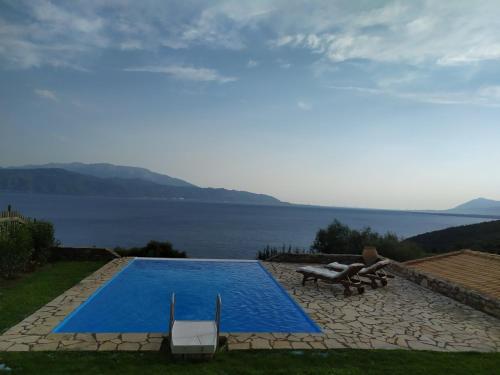 a swimming pool with a view of the water at PRINCESS OF BLUE EAGLES RETREAT in Skaloma