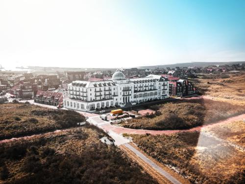 an aerial view of a large white building at Strandhotel Kurhaus Juist in Juist