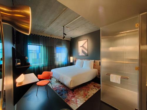 ホーフトドルプにあるThe Florian Amsterdam Airport, WorldHotels Craftedのベッドとバスルームがあるホテルの部屋