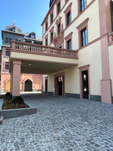 a large building with a walkway in front of it at DEINHARD's in Bernkastel-Kues