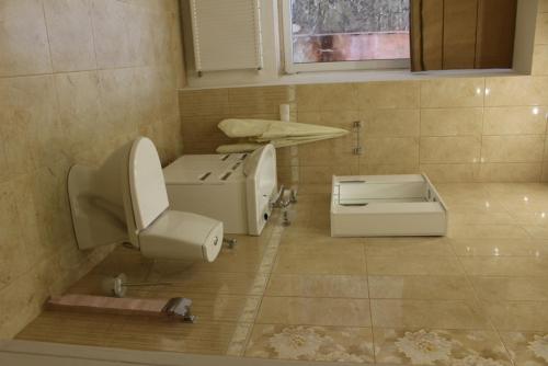 a bathroom with a toilet and a sink at Apartment Novyj Svit in Lviv