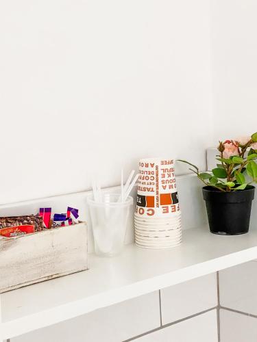 a white shelf with plants and utensils on it at Etzel Tami Hospitality in Neot Golan