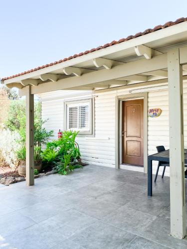 a patio with awning on a house at Etzel Tami Hospitality in Neot Golan