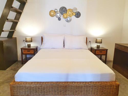a bedroom with a large bed with two night stands at Navita Cave Houses in Fira