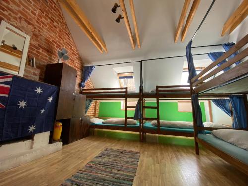 a room with two bunk beds and a rug at Jimmy Jumps House in Vilnius