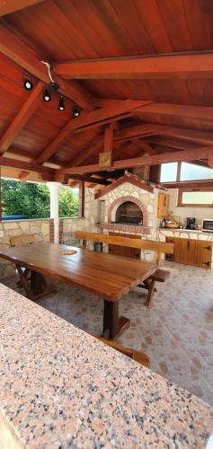 a large room with wooden tables and a stone oven at Apartments Alicia Lopar-50m vom Strand in Lopar