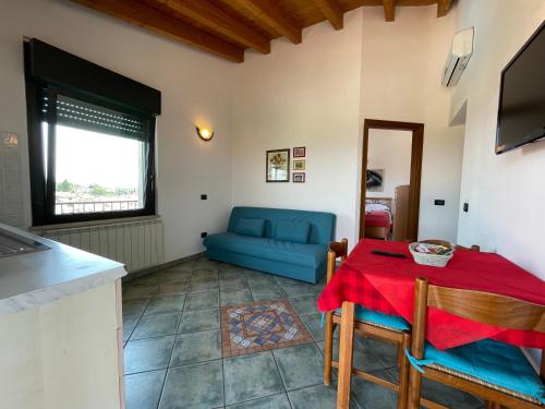 a living room with a table and a blue couch at Residence Bellavista in Manerba del Garda