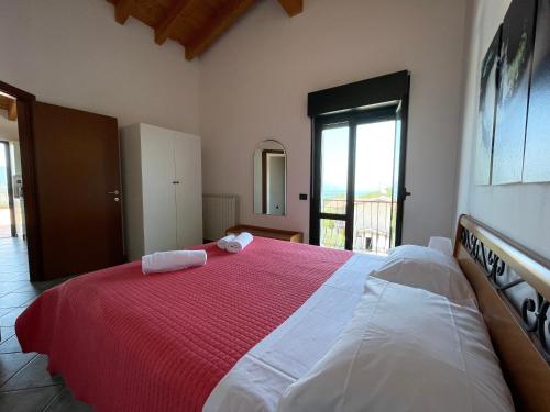 a bedroom with a large bed with two towels on it at Residence Bellavista in Manerba del Garda
