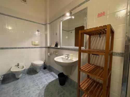 a bathroom with a sink and a toilet and a mirror at Residence Bellavista in Manerba del Garda