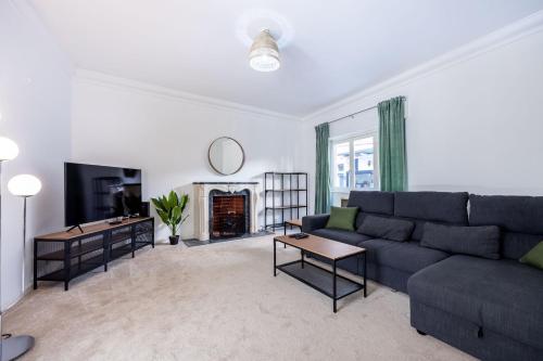 a living room with a couch and a fireplace at Green Urban Oasis in Portimão