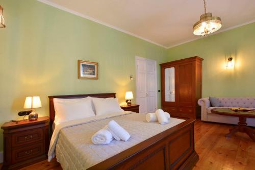 a bedroom with a bed with towels on it at History House in Corfu Town