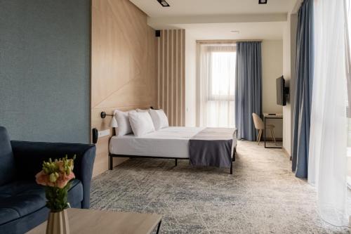 a hotel room with a bed and a couch at Rooftop Apart-Hotel in Yerevan