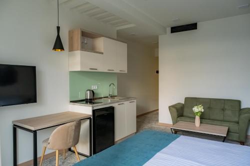 a kitchen and living room with a couch and a table at Rooftop Apart-Hotel in Yerevan