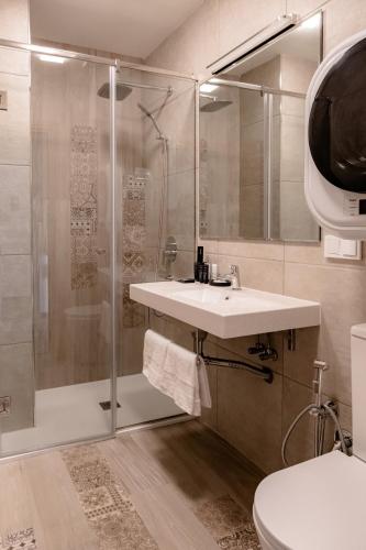 a bathroom with a shower and a sink and a toilet at Rooftop Apart-Hotel in Yerevan