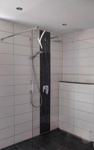 a bathroom with a shower with a glass door at Ferienhaus Rasch in Maierhöfen