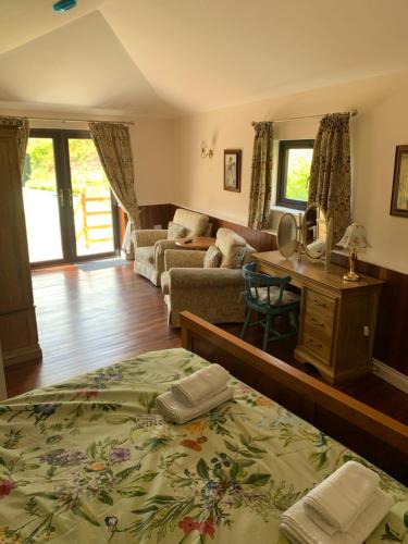 a bedroom with a bed and a living room at Neuadd Villa in Llanwnen