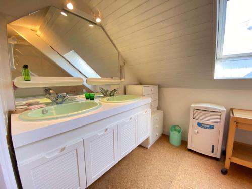 une salle de bain avec deux lavabos et un miroir dans l'établissement Appartement duplex 5 pièces, 6 couchages au cœur de La Baule avec terrasse, parking et tous commerces à pied - FR-1-245-71, à La Baule