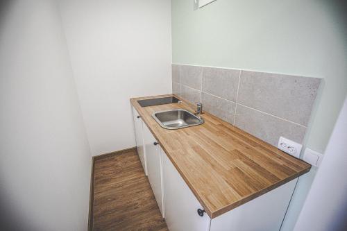 a small bathroom with a sink and a counter at Urban House - Ada in Ada